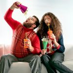 Two geeks eating popcorn