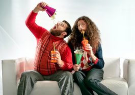 Two geeks eating popcorn