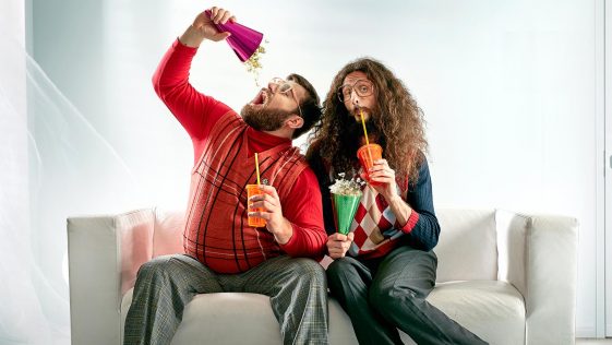 Two geeks eating popcorn